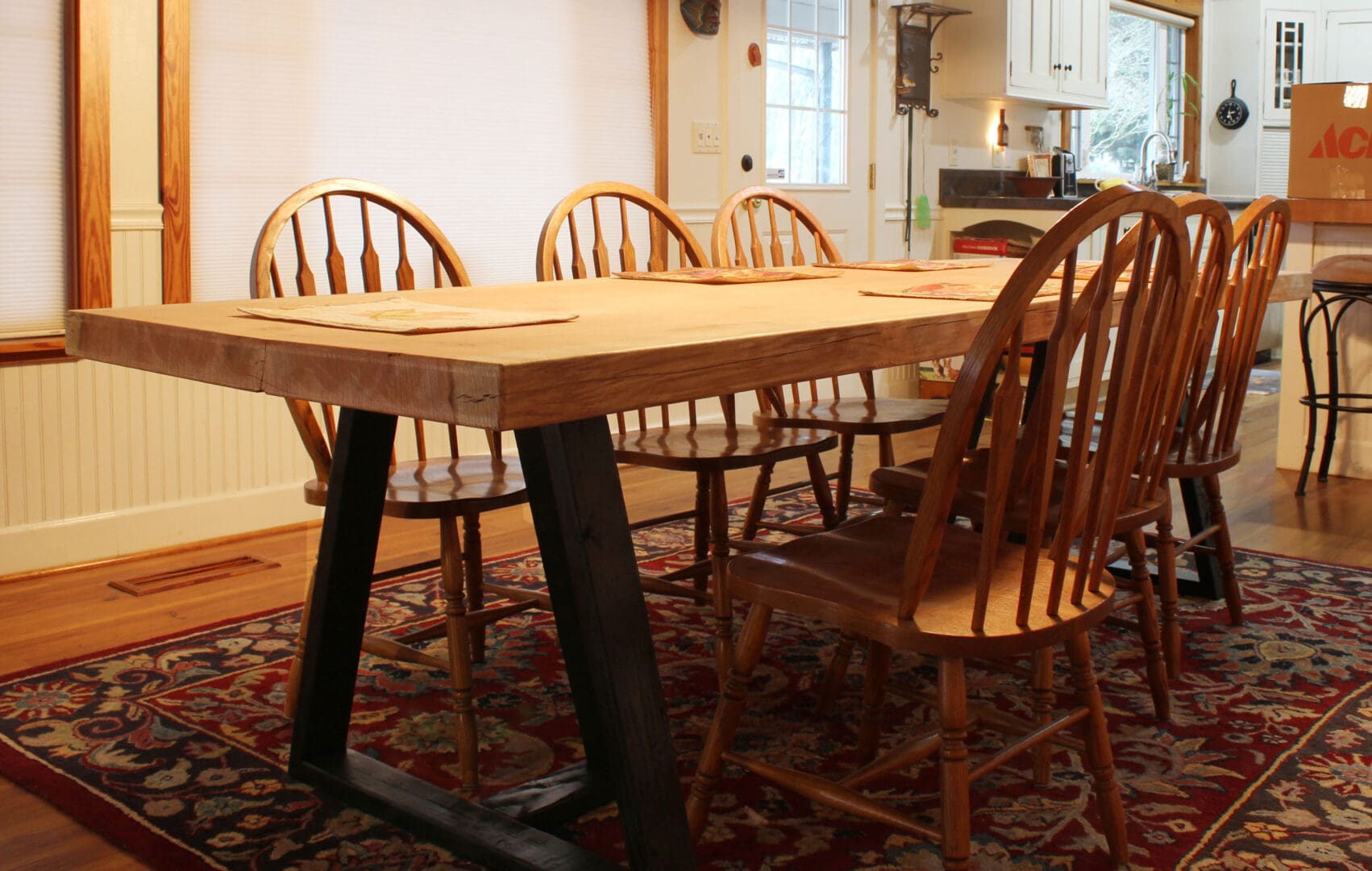 A table with four chairs in the middle of it.