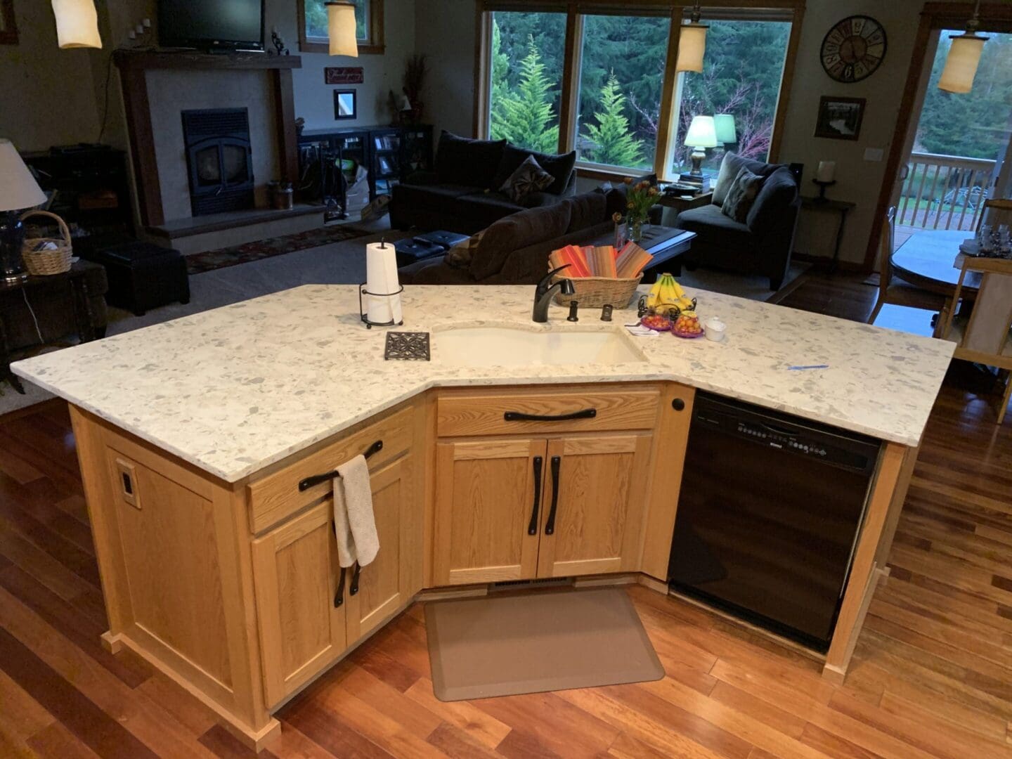 A kitchen with wood cabinets and white countertops.