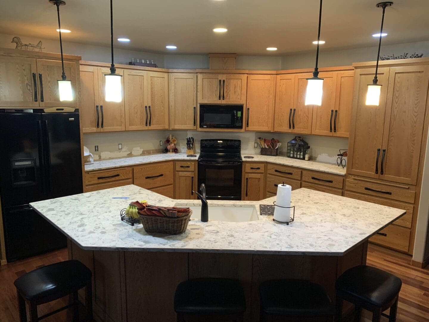 A kitchen with an island and many lights